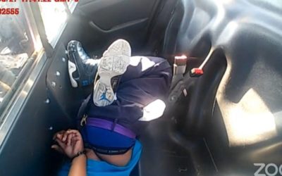 Cop “punishes” Black woman by leaving her hogtied and in a face-down position in back of cop car